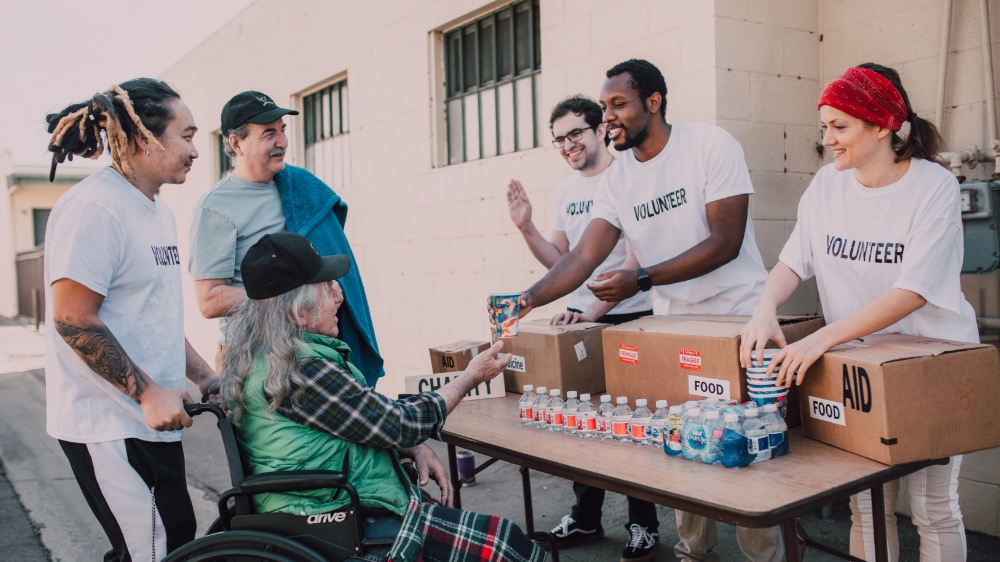 Volunteers handing out food and water at a community event