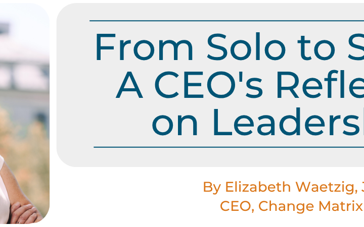 A promotional graphic displays the title "From Solo to Shared: A CEO's Reflection on Leadership" in large teal text inside a light grey box. Below the title, orange text identifies the author as "By Elizabeth Waetzig, JD CEO, Change Matrix." To the left, a professional headshot shows Elizabeth Waetzig smiling warmly with her arms crossed, wearing a white top.
