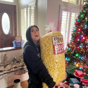 Ryza holding a big bag of popcorn around the holidays