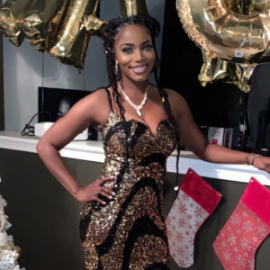 A photo of Carra during the holidays wearing a black and gold sequined dress.